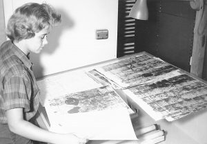 Black and White photo of woman looking at map